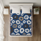 Valu Floral Cotton Throw Blanket in Blue, on a bed