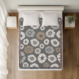 Valu Floral Cotton Throw Blanket in Gray, on a bed