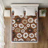 Valu Floral Cotton Throw Blanket in Rust Brown, on a bed