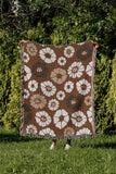 Valu Floral Cotton Throw Blanket in Rust Brown, outdoors