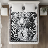 Fiero Leopard Cotton Blend Blanket Throw in Black and Off-White, on a bed
