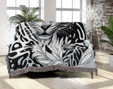 Fiero Leopard Cotton Blend Blanket Throw in Black and Off-White, draped over a chair