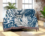Fiero Leopard Cotton Blend Blanket Throw in Blue and Off-White, draped over a chair