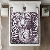 Fiero Leopard Cotton Blend Blanket Throw in Purple and Off-White, on a bed
