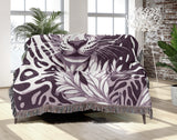 Fiero Leopard Cotton Blend Blanket Throw in Purple and Off-White, draped over a chair