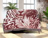 Fiero Leopard Cotton Blend Blanket Throw in Red and Off-White, draped over a chair