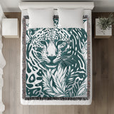 Fiero Leopard Cotton Blend Blanket Throw in Teal and Off-White, on a bed