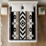 Fika Southwestern Cotton Blend Blanket Throw in Beige, Black and Off-White, on a bed