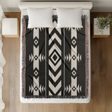 Fika Southwestern Cotton Blend Blanket Throw in Black and Off-White, on a bed