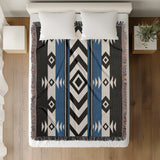 Fika Southwestern Cotton Blend Blanket Throw in Blue, Black and Off-White, on a bed
