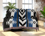 Fika Southwestern Cotton Blend Blanket Throw in Blue, Black and Off-White, draped over a chair