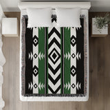 Fika Southwestern Cotton Blend Blanket Throw in Green, Black and Off-White, on a bed