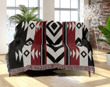 Fika Southwestern Cotton Blend Blanket Throw in Red, Black and Off-White, draped over a chair