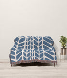 Freda Hand Woven Throw Blanket in Blue and Beige, draped over a sofa