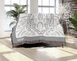 Hero Tibetan Tiger Cotton Blend Blanket Throw in Gray and Off-White, draped over a chair