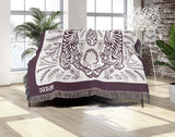 Hero Tibetan Tiger Cotton Blend Blanket Throw in Purple and Off-White, draped over a chair