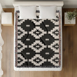 Hinto Southwestern Cotton Blend Blanket Throw in Black and Off-White, on a bed