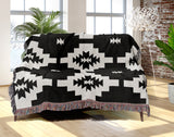 Hinto Southwestern Cotton Blend Blanket Throw in Black and Off-White, draped over a chair