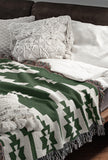 Hinto Southwestern Cotton Blend Blanket Throw in Green and Off-White, draped over a chair
