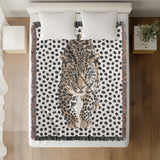 Inky Leopard Cotton Blend Blanket Throw in Beige, Gray and Off-White, on a bed