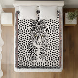 Inky Leopard Cotton Blend Blanket Throw in Black and Off-White, on a bed