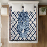 Inky Leopard Cotton Blend Blanket Throw in Blue and Off-White, on a bed