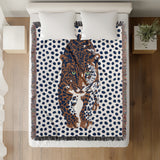 Inky Leopard Cotton Blend Blanket Throw in Blue, Burnt Orange and Off-White, on a bed