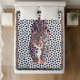 Inky Leopard Cotton Blend Blanket Throw in Blue, Light Pink and Off-White, on a bed