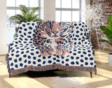 Inky Leopard Cotton Blend Blanket Throw in Blue, Light Pink and Off-White, draped over a chair