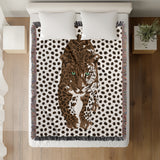 Inky Leopard Cotton Blend Blanket Throw in Black, Rust Brown and Off-White, on a bed
