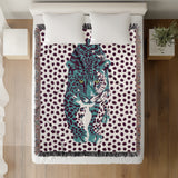 Inky Leopard Cotton Blend Blanket Throw in Teal, Purple and Off-White, on a bed