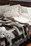 Jansen Cotton Blend Blanket Throw in Black, on a bed