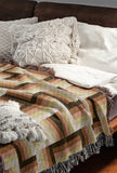 Jansen Cotton Blend Blanket Throw in Burnt Orange, on a bed