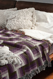 Jansen Cotton Blend Blanket Throw in Purple, on a bed