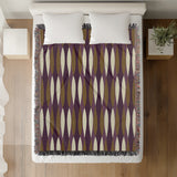 Jordyn Cotton Blend Blanket Throw in Purple, on a bed