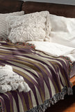 Jordyn Cotton Blend Blanket Throw in Purple, draped over a chair