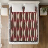 Jordyn Cotton Blend Blanket Throw in Red, on a bed