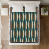 Jordyn Cotton Blend Blanket Throw in Teal, on a bed