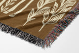 Josu Giraffe Cotton Blend Blanket Throw in Beige and Off-White, draped over a chair