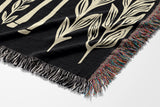 Josu Giraffe Cotton Blend Blanket Throw in Black and Off-White, on a bed