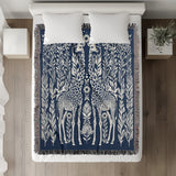 Josu Giraffe Cotton Blend Blanket Throw in Blue and Off-White, on a bed