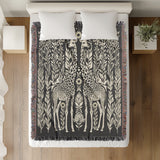 Josu Giraffe Cotton Blend Blanket Throw in Gray and Off-White, on a bed