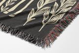 Josu Giraffe Cotton Blend Blanket Throw in Gray and Off-White, draped over a chair