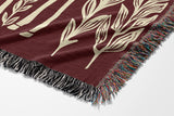 Josu Giraffe Cotton Blend Blanket Throw in Red and Off-White, draped over a chair