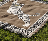 Kat Tiger Cotton Blend Blanket Throw in Beige and Off-White, draped over a chair