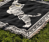 Kat Tiger Cotton Blend Blanket Throw in Black and Off-White, draped over a chair