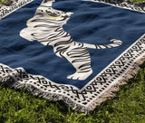Kat Tiger Cotton Blend Blanket Throw in Blue and Off-White, draped over a chair