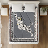 Kat Tiger Cotton Blend Blanket Throw in Gray and Off-White, on a bed