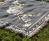 Kat Tiger Cotton Blend Blanket Throw in Gray and Off-White, draped over a chair