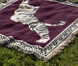 Kat Tiger Cotton Blend Blanket Throw in Purple and Off-White, draped over a chair